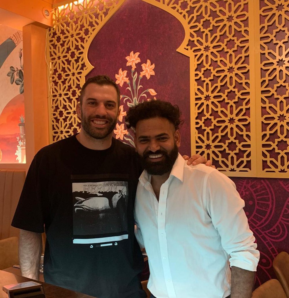 Giri, owner of Urban Spices, with a guest in the dining room